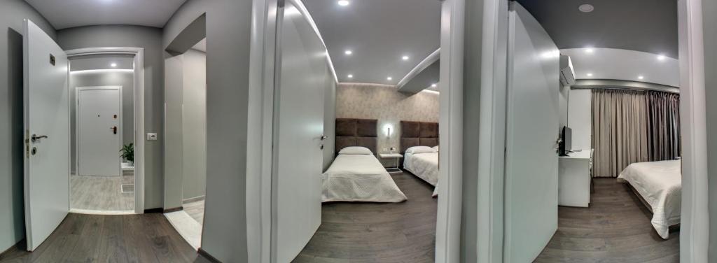 a hotel room with two beds and a hallway at Hotel Oresti Center in Tirana