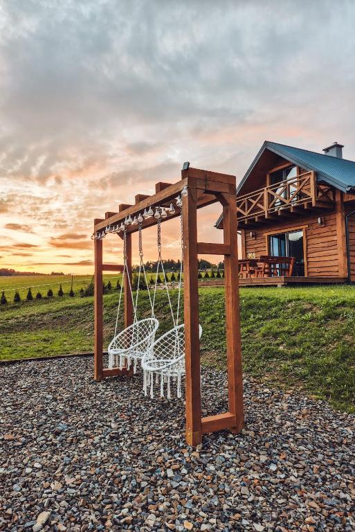 a swing set in front of a cabin at Chata Rajski Widok in Baligród