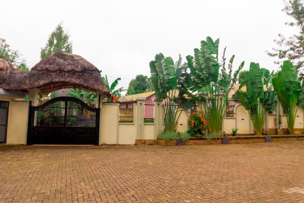 a gate to a house with a bunch of plants at Fortis Hill Hotel in Arusha