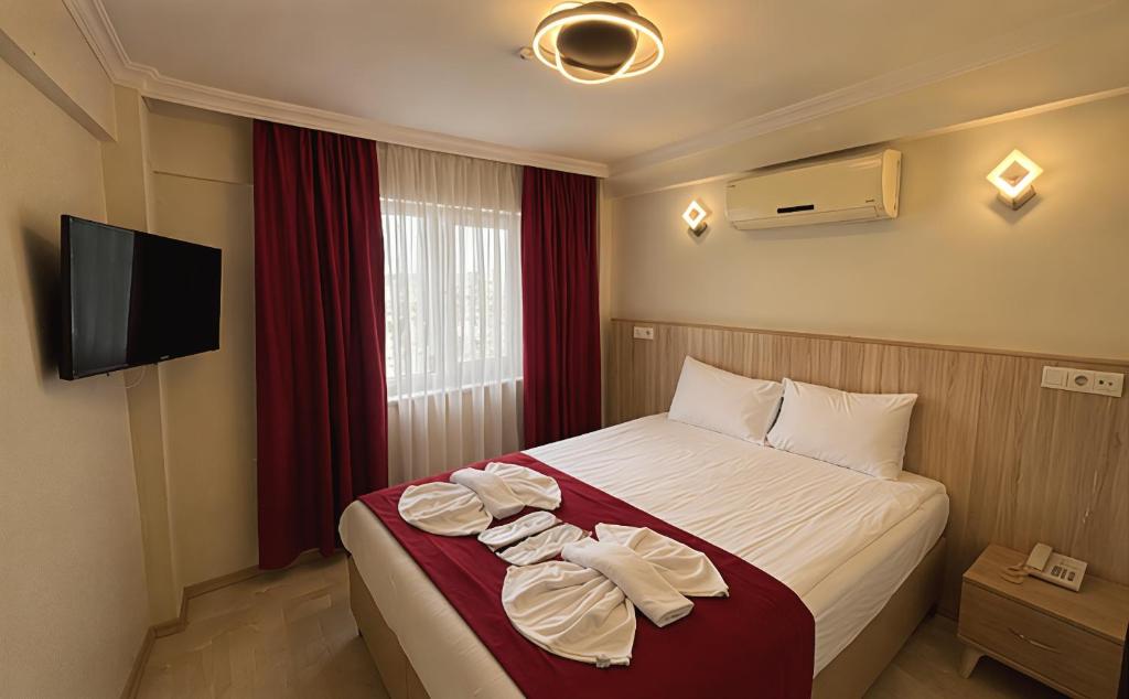 a hotel room with a bed and a flat screen tv at Le Safran Palace in Istanbul