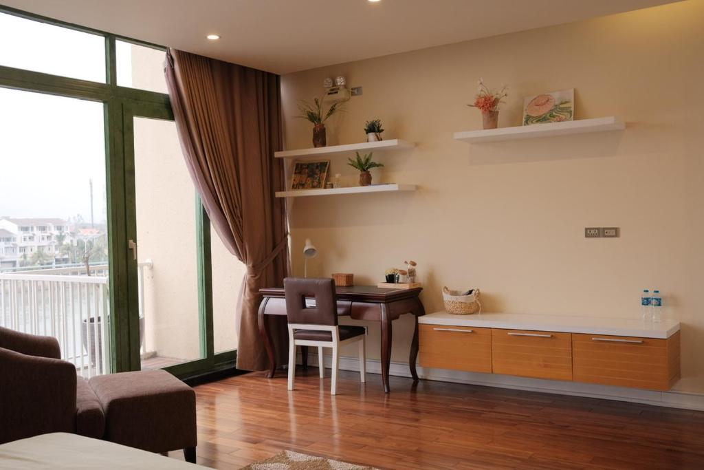 a room with a desk and a table with chairs at Lam Home Tuần Châu in Ha Long