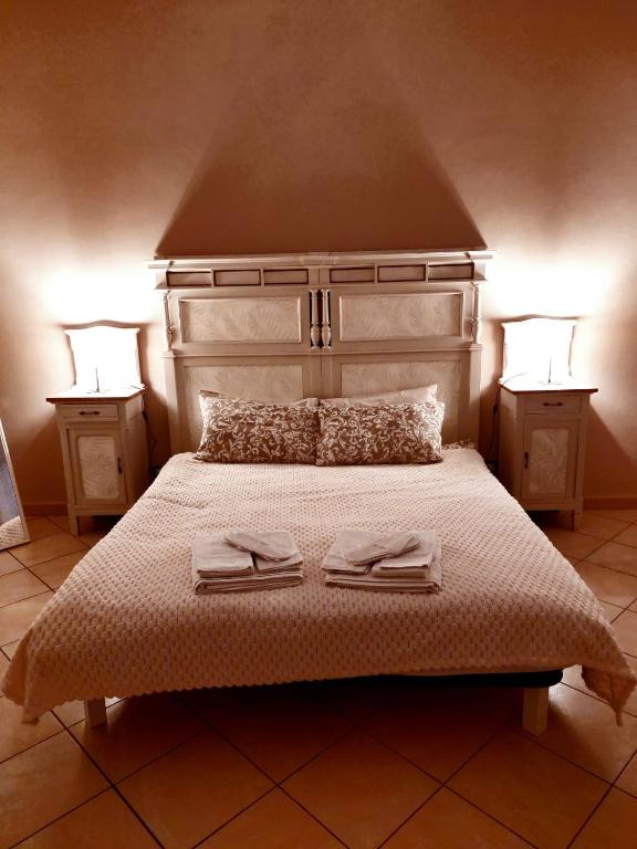 a bedroom with a bed with two towels on it at La Finestra sulla Storia in Asti
