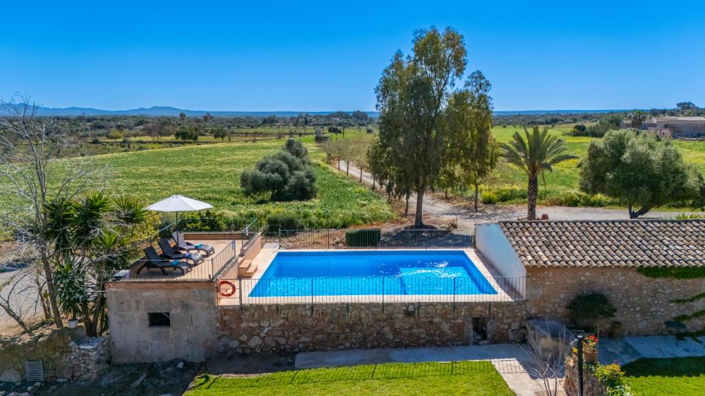 an external view of a villa with a swimming pool at Finca Agroturismo Sa Cova den Borino in Campos