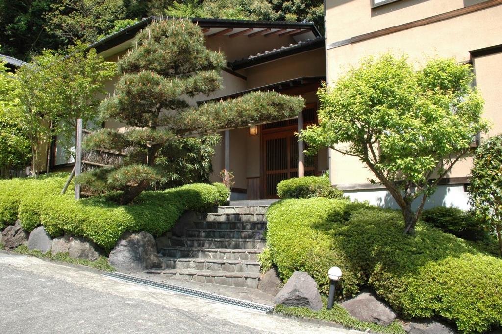 uma casa com escadas em frente a um edifício em Hoshi Meguri em Shimoda