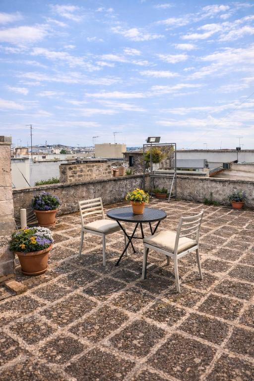 a patio with a table and two chairs on a roof at La Puteca di Nonna Cia in Andrano