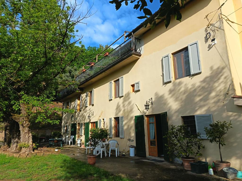 a large white house with a table and chairs at L'Antica Dimora Toscana in Cecina