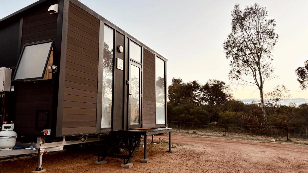 a black tiny house sitting on a trailer at Hill River Nature Reserve by Tiny Away in Jurien Bay