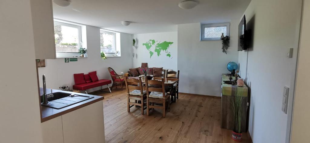 a kitchen and a dining room with a table and chairs at Rheinufer in Xanten