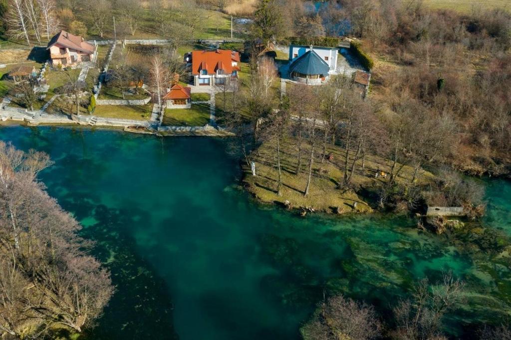 an aerial view of a house next to a river at Villa ENT in Bihać