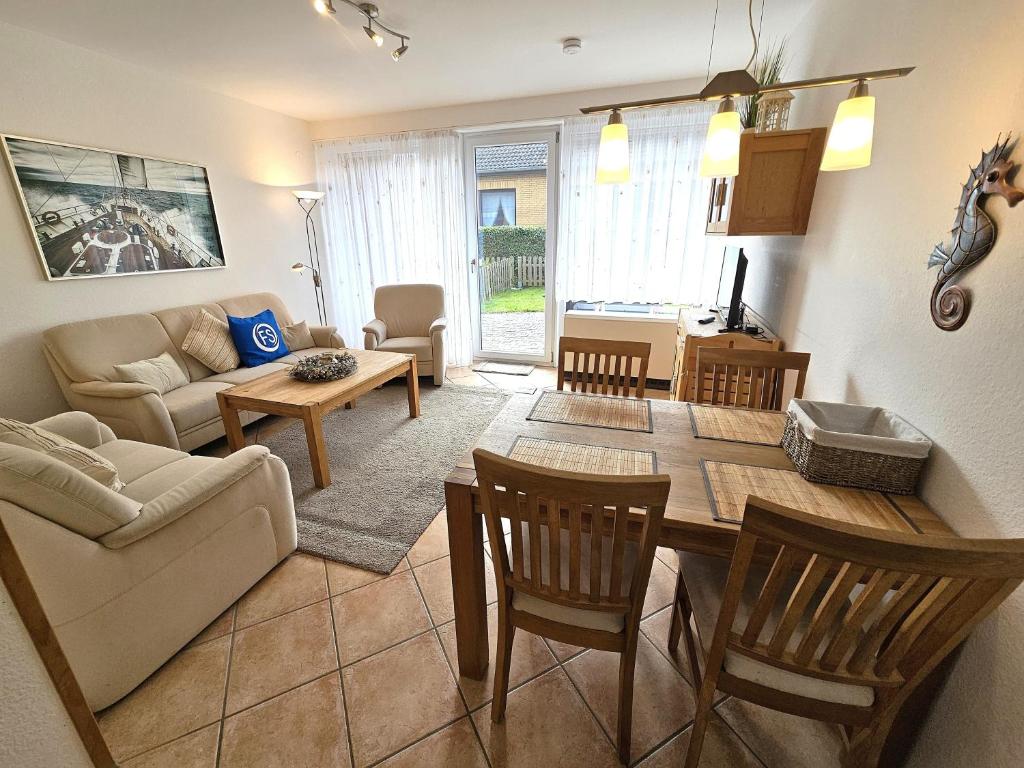 a living room with a couch and a table at Reihenhaus Donna in Dahme
