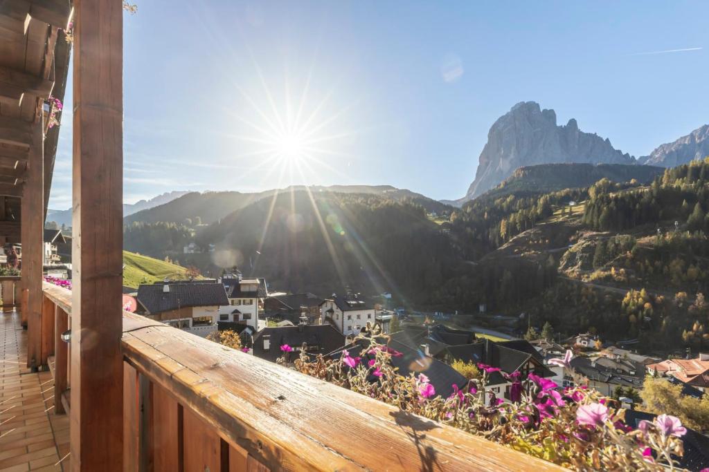 a view from the balcony of a house with flowers at Kedul Lodge in Santa Cristina Gherdëina