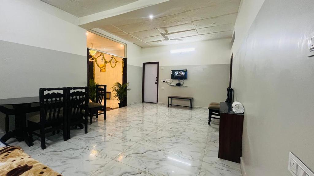 a living room with a piano and a dining room at Twinkle Clouds Home Stay in Chikmagalūr