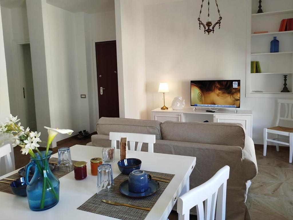 a living room with a couch and a table at Turquoise Horizon in Stintino