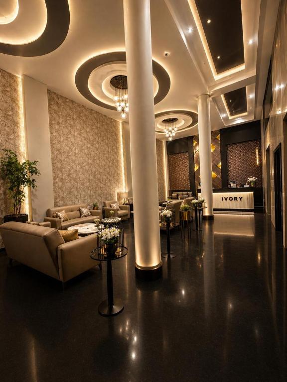 a lobby with couches and tables in a building at The Ivory Hotel in Nairobi