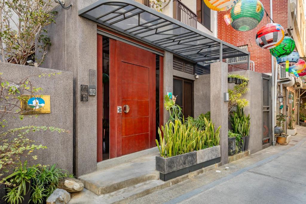 a red door on the side of a building at 傅棧 Fu Yu in Tainan
