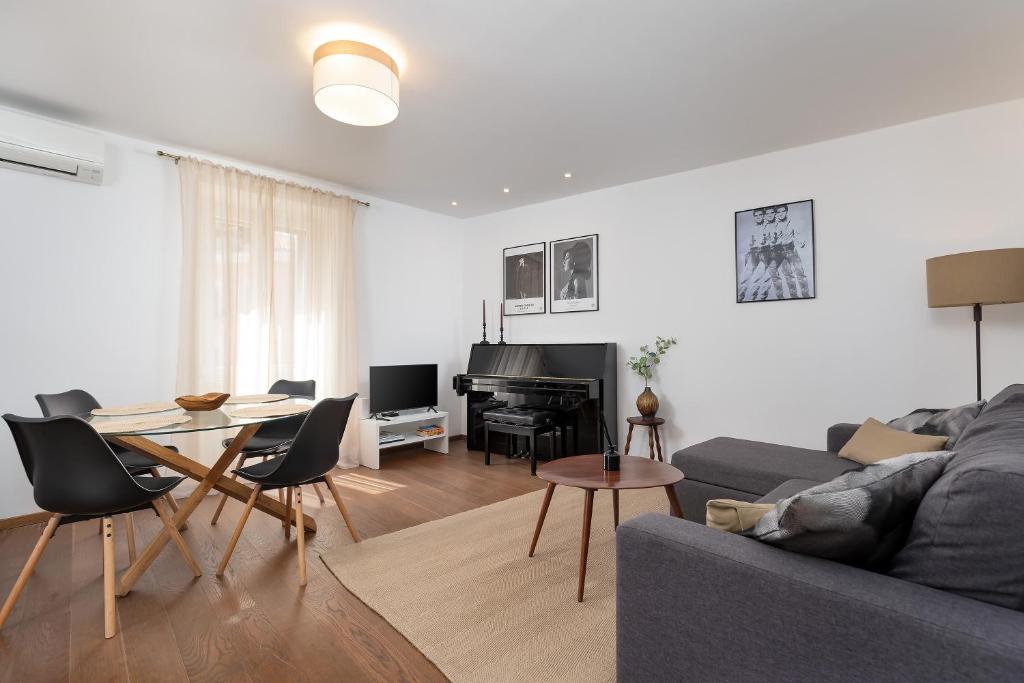 a living room with a couch and a table at Apartment Lassy by Irundo in Rovinj