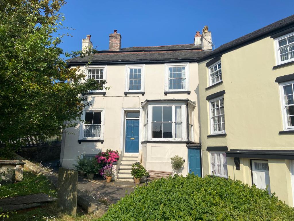 a large white house with a blue door at Studio at Church House in Bideford