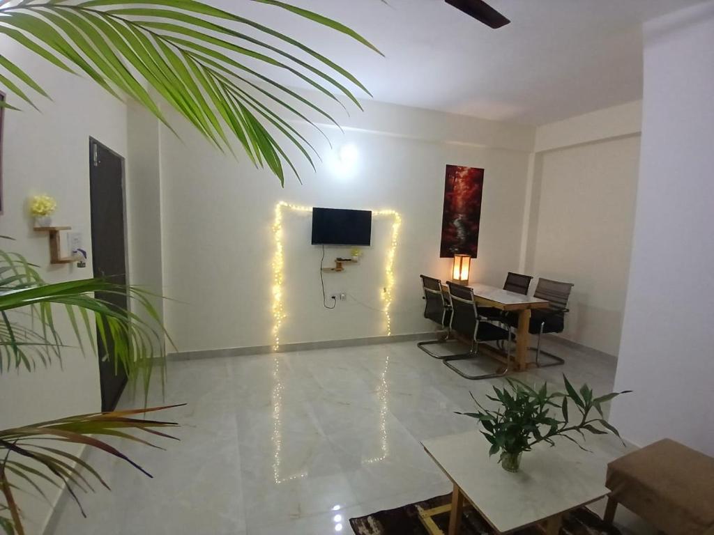 a living room with a table and a television at O2 Homes in Guwahati