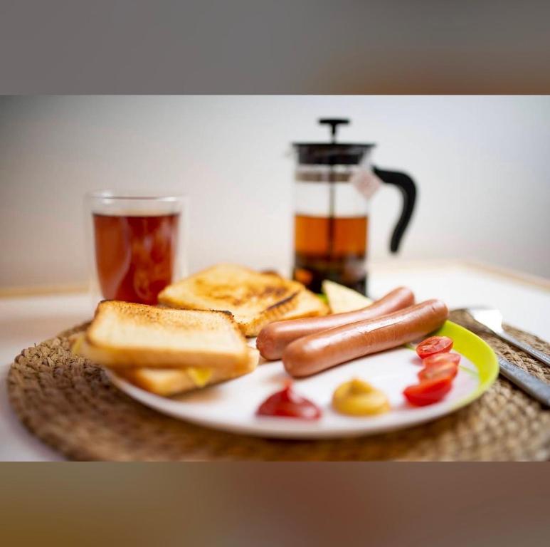 a plate of food with two hot dogs and toast at Grand Hostel - Free Breakfast in Katowice
