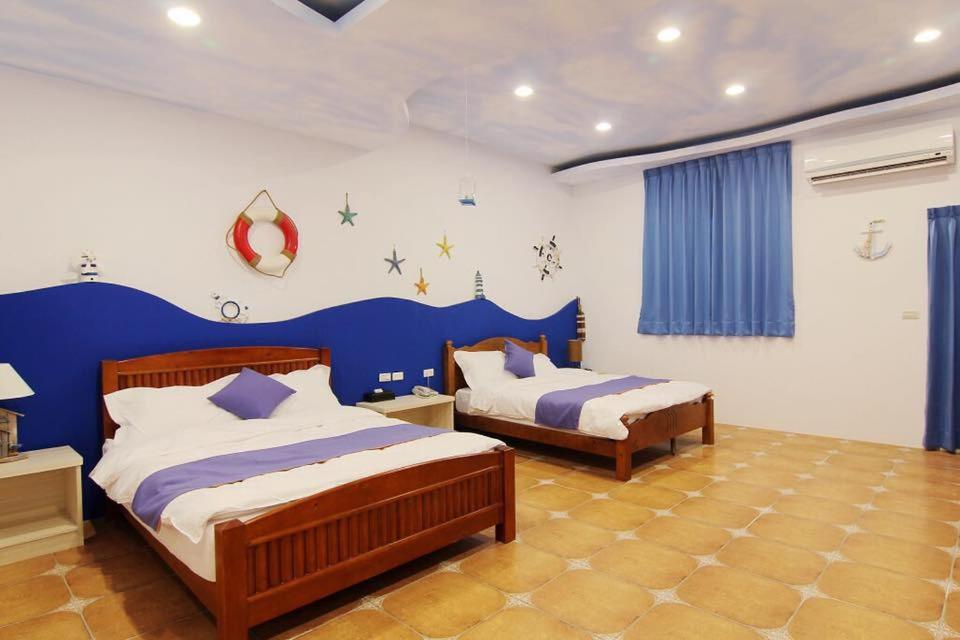 Postel nebo postele na pokoji v ubytování Zi Jìng Fang Inn