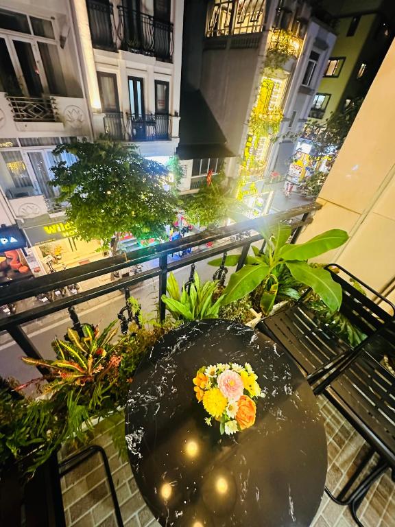 a table with flowers sitting on top of a building at Supper Location City view 3Br 5CG in Hanoi