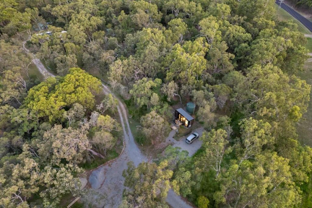 an aerial view of a house in the middle of a forest at Wildlife Haven by Tiny Away in Agnes Water