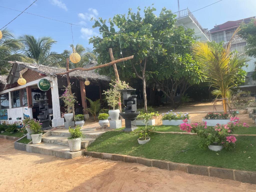 a small building with plants in front of it at D & D Beach Resort in Trincomalee