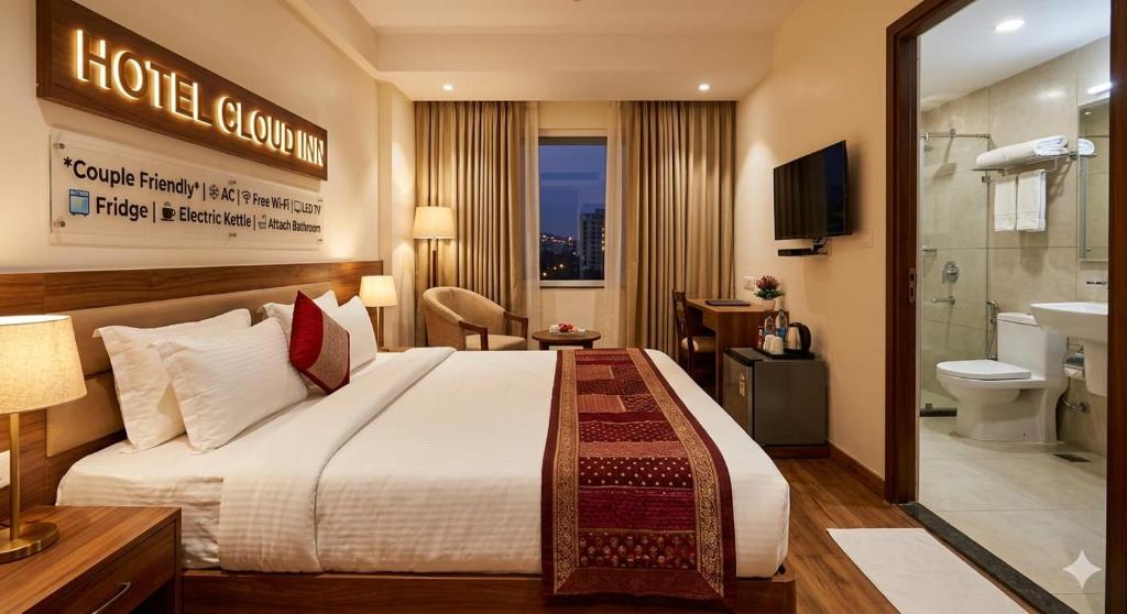 a hotel room with a large bed and a bathroom at Hotel Cloud Inn in New Delhi