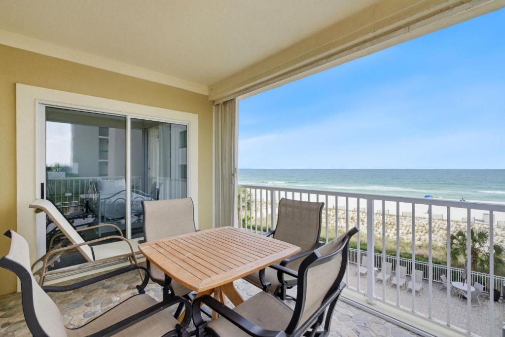 a balcony with a table and chairs and the ocean at Marlin Key 2A in Orange Beach