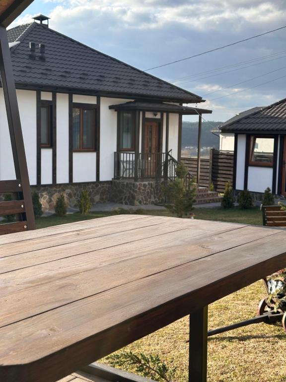 a wooden deck in front of a house at Five House in Skhidnitsa