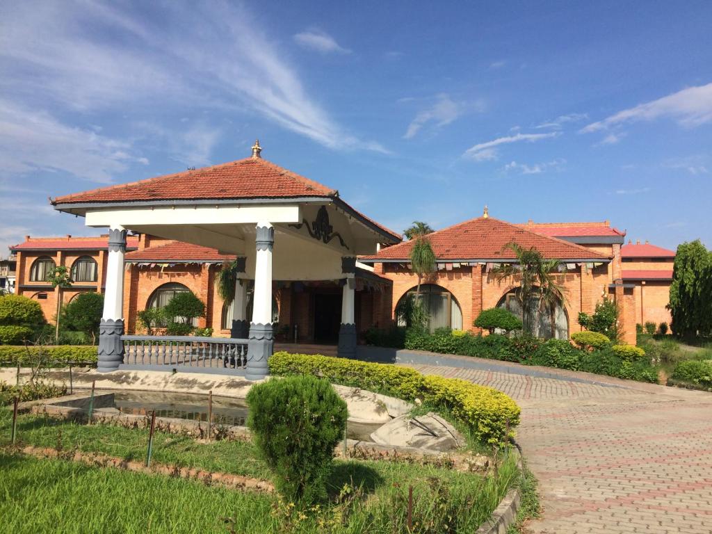 a building with a gazebo in a yard at Hotel Lumbini Garden New Crystal in Rummindei
