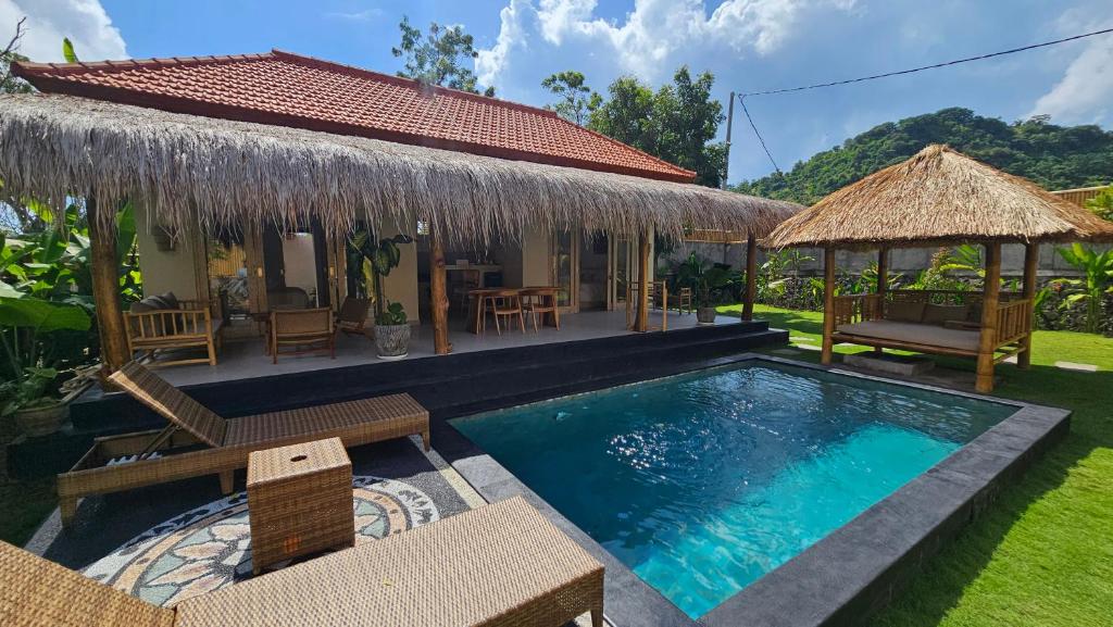 a villa with a swimming pool and a resort at Amed Saïta Villas in Amed