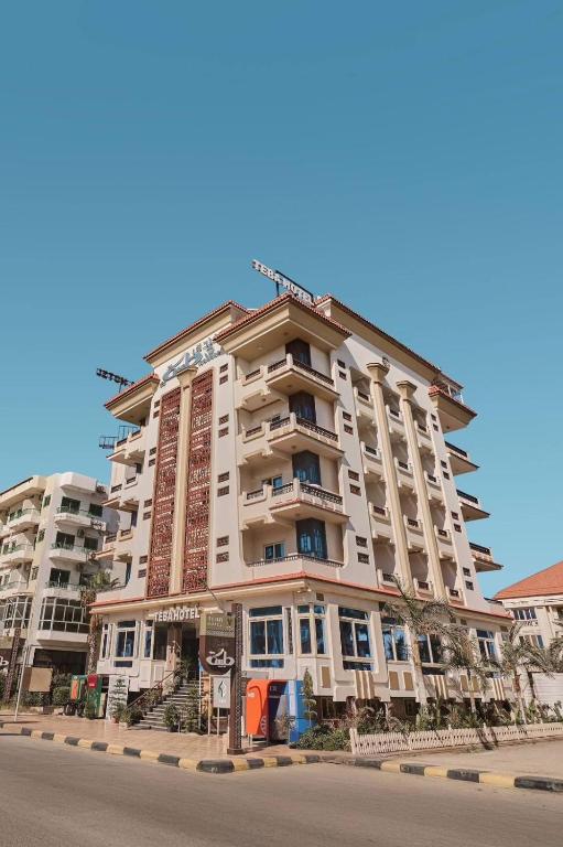 a tall building on the side of a street at Teba Hotel Ras Elbar in Ras El Bar