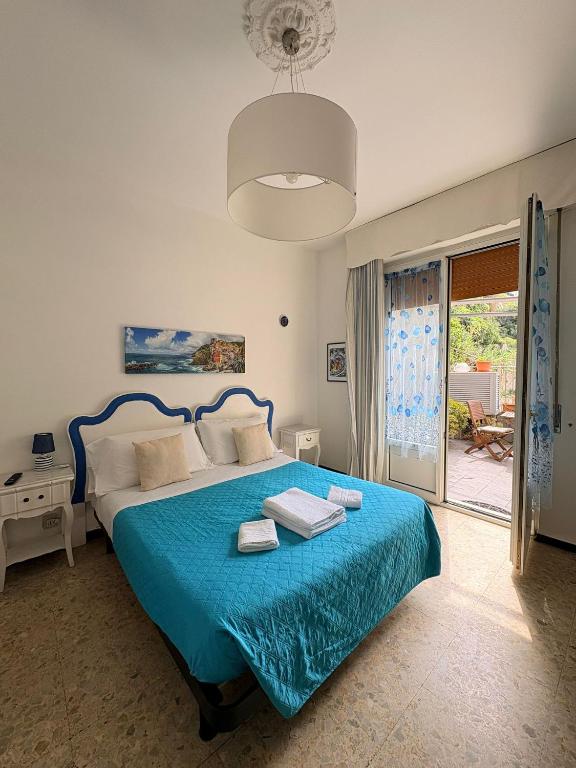 a bedroom with a bed with a blue bedspread at Dreaming Rooms in Riomaggiore