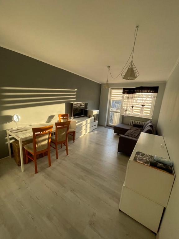 a living room with a table and a couch at U Damiana in Gdańsk
