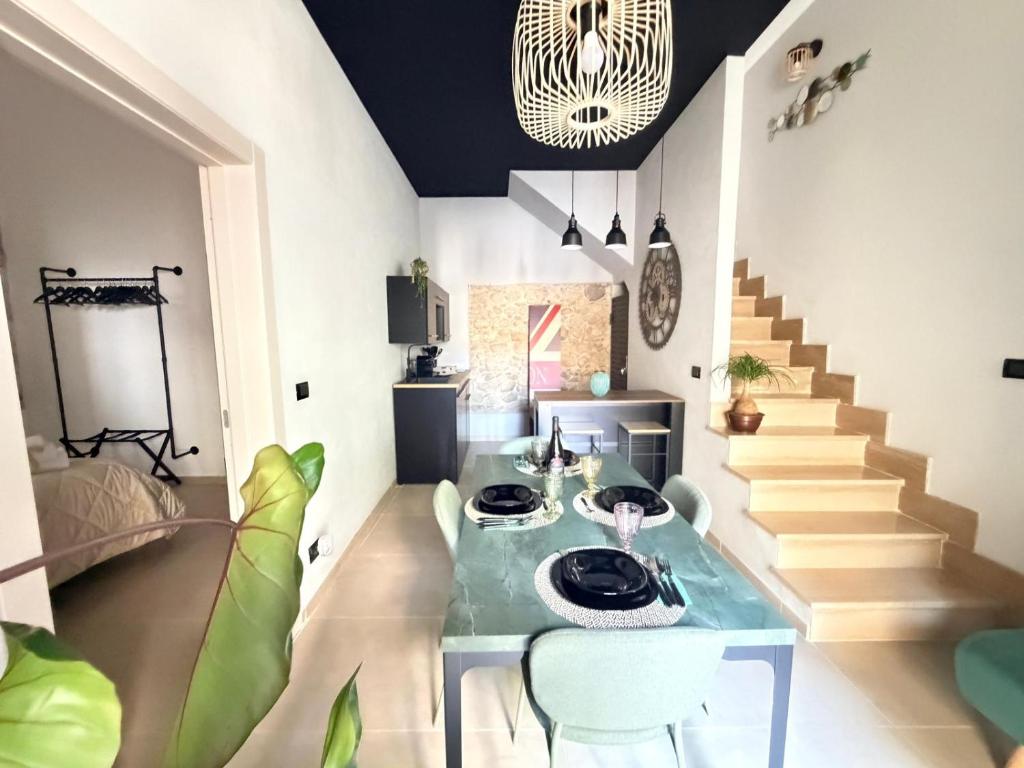 a living room with a glass table and stairs at Kymata Home in Avola