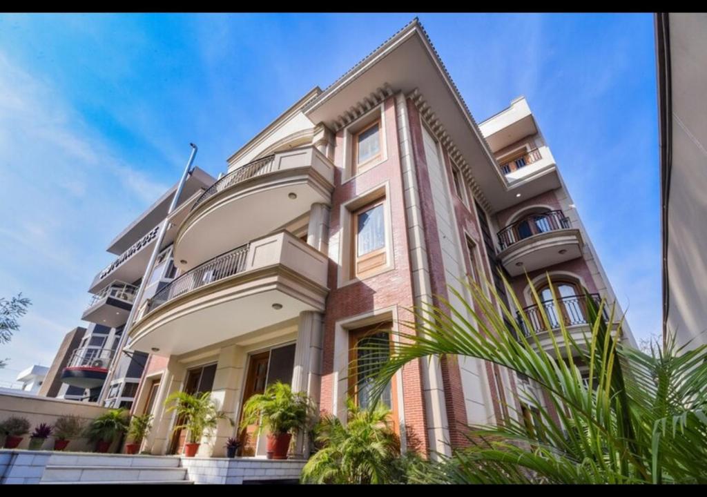 a large building with plants in front of it at Royal Residence Golf Course Road in Gurgaon