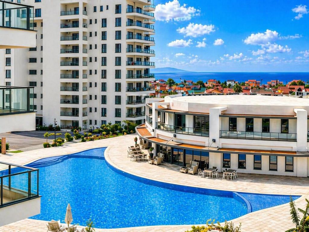 an aerial view of a building with a swimming pool at Caesar Blue Collection Nothern Cyprus Studios & Spa Resort in Kaimakli