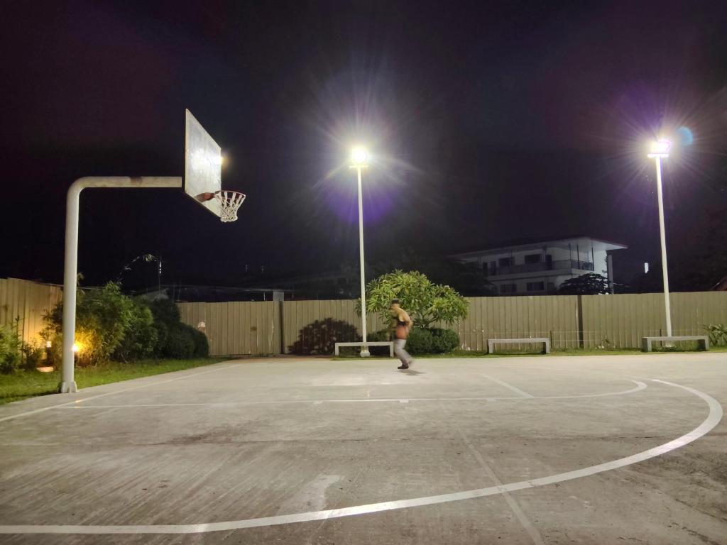 a man playing basketball on a basketball court at night at Zefe's Hideout in Lapu Lapu City