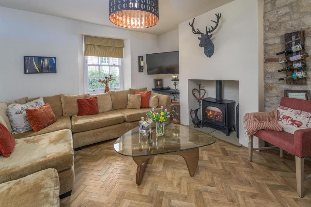 a living room with a couch and a table and a fireplace at 2 Bed in Warkworth oc-coq95 in Warkworth
