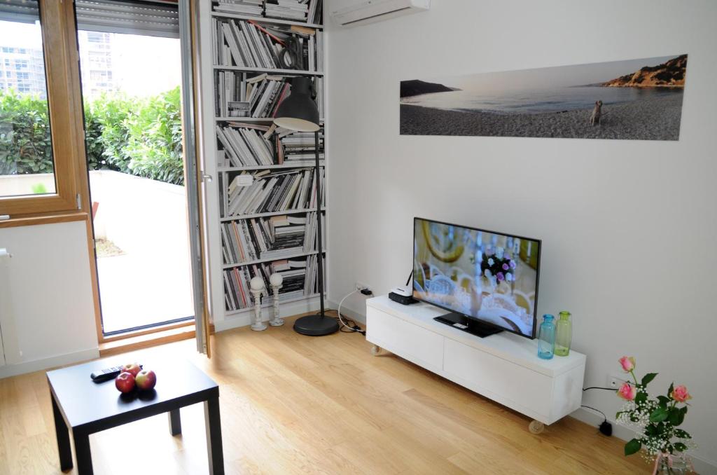 a living room with a television and a book shelf at Apartment Block A in Belgrade