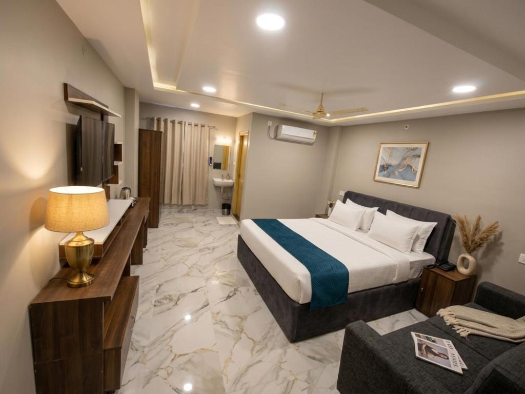a hotel room with a bed and a couch at Hotel HiCity Comfort Near DLF Cyber City & AIG Hospital in Hyderabad