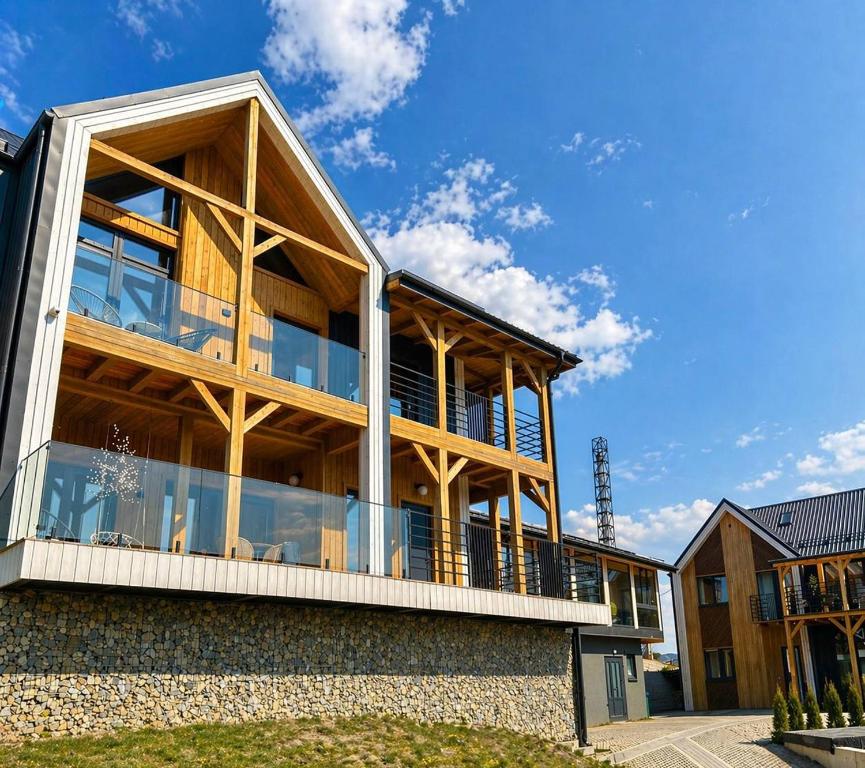 a house with a large deck on the side of it at Шале Green Land in Bukovel