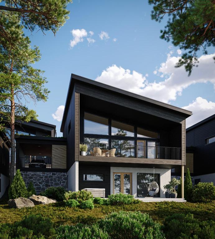 a modern house with a black facade at TAHKO LAKESIDE VILLA D 3 in Tahkovuori