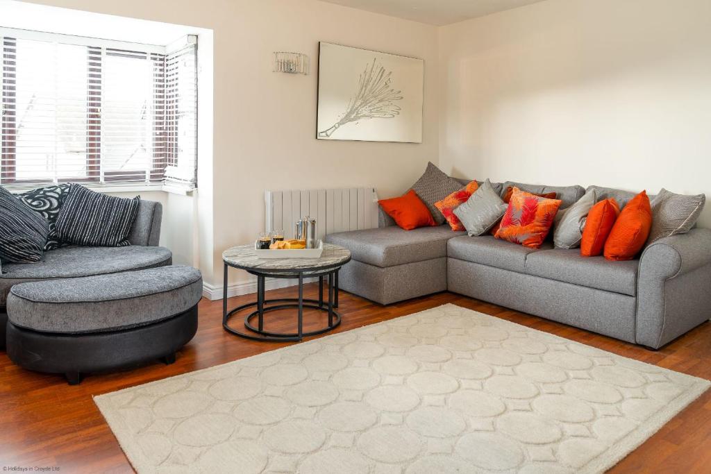 a living room with a couch and a chair at Kernow House in Croyde