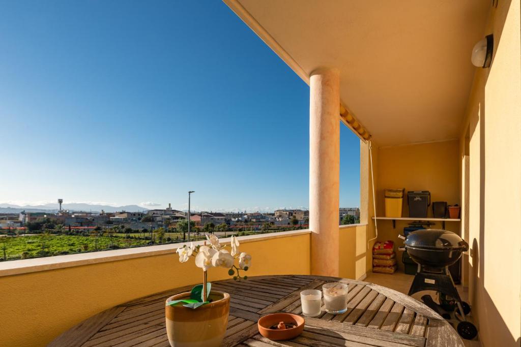 a balcony with a table with a view of a city at Casa Dudú in Quartucciu