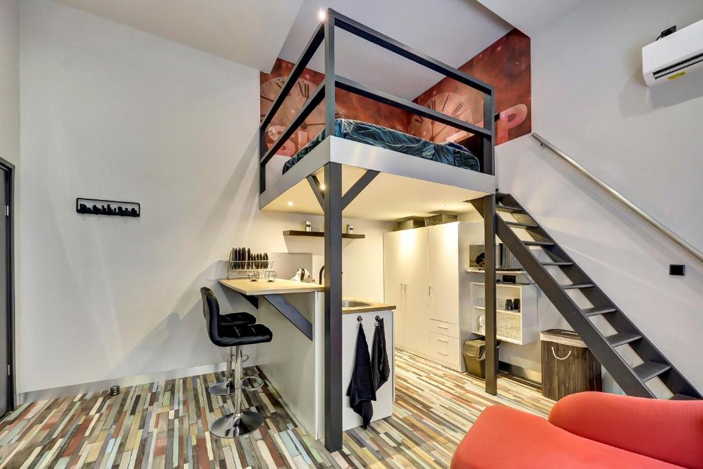 a loft office with a staircase and a desk at Stijlvolle Designstudio in Almere