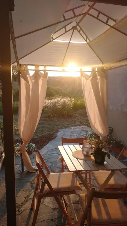 a table and chairs under an umbrella on a patio at La Libellula in Capannoli