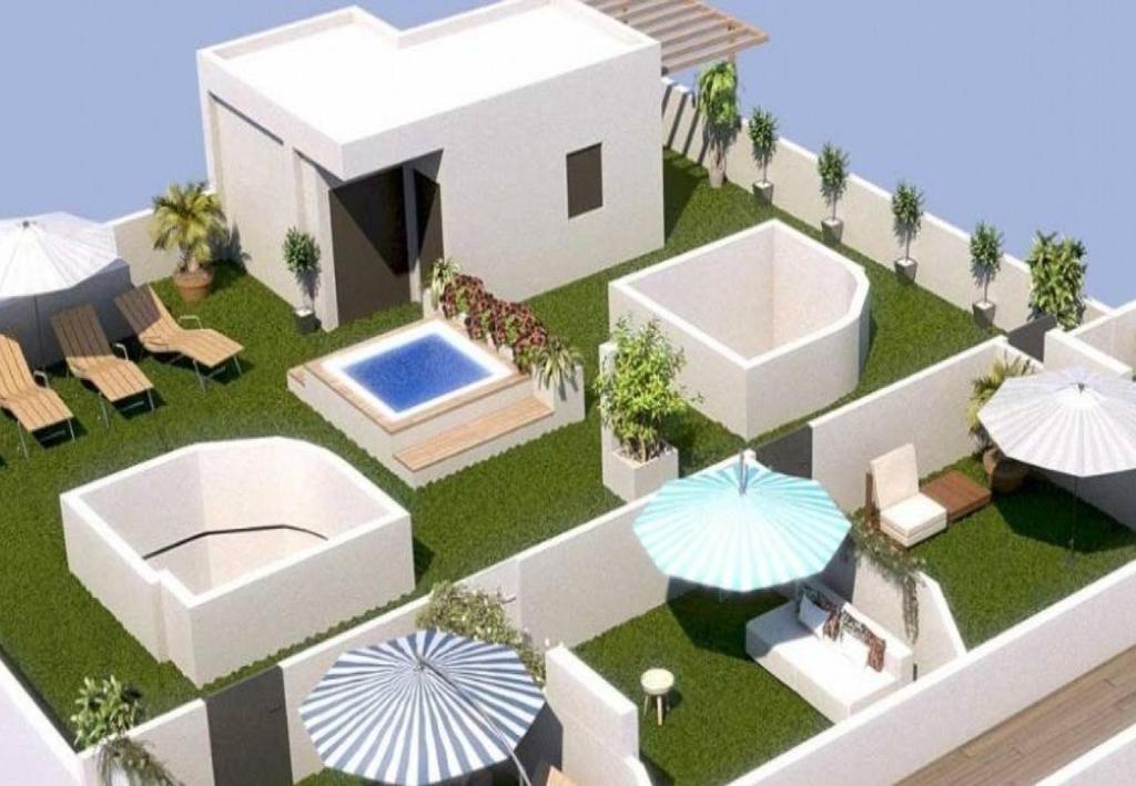 a model of a house with a swimming pool and umbrellas at Apartamento Lujoso Centro Torrevieja in Torrevieja