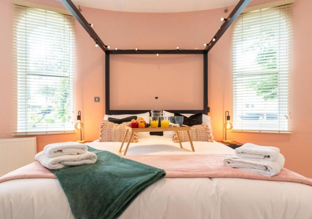 a bedroom with a large bed with towels on it at Spacious 3 bed, Parking, Long stays welcome, Relocators, Families, Contractors in Knaresborough